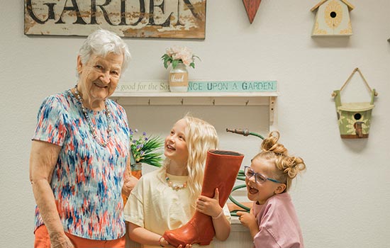 Senior Enjoying with kids Senior woman smiles with kids thanks to memory care living in Fresno