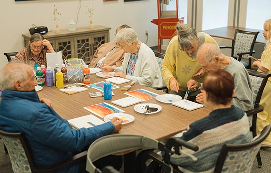 Group of Senior Painting Seniors painting in group as part of memory care living in Fresno